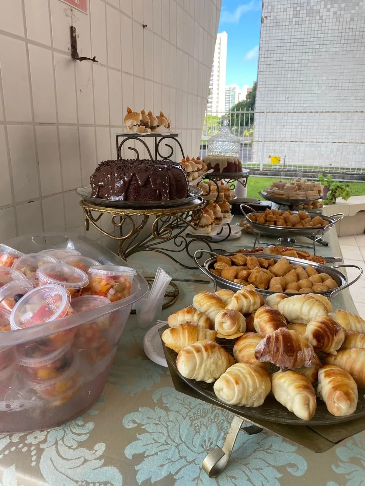 Salgados e bolo de chocolate em buffet de coffee break